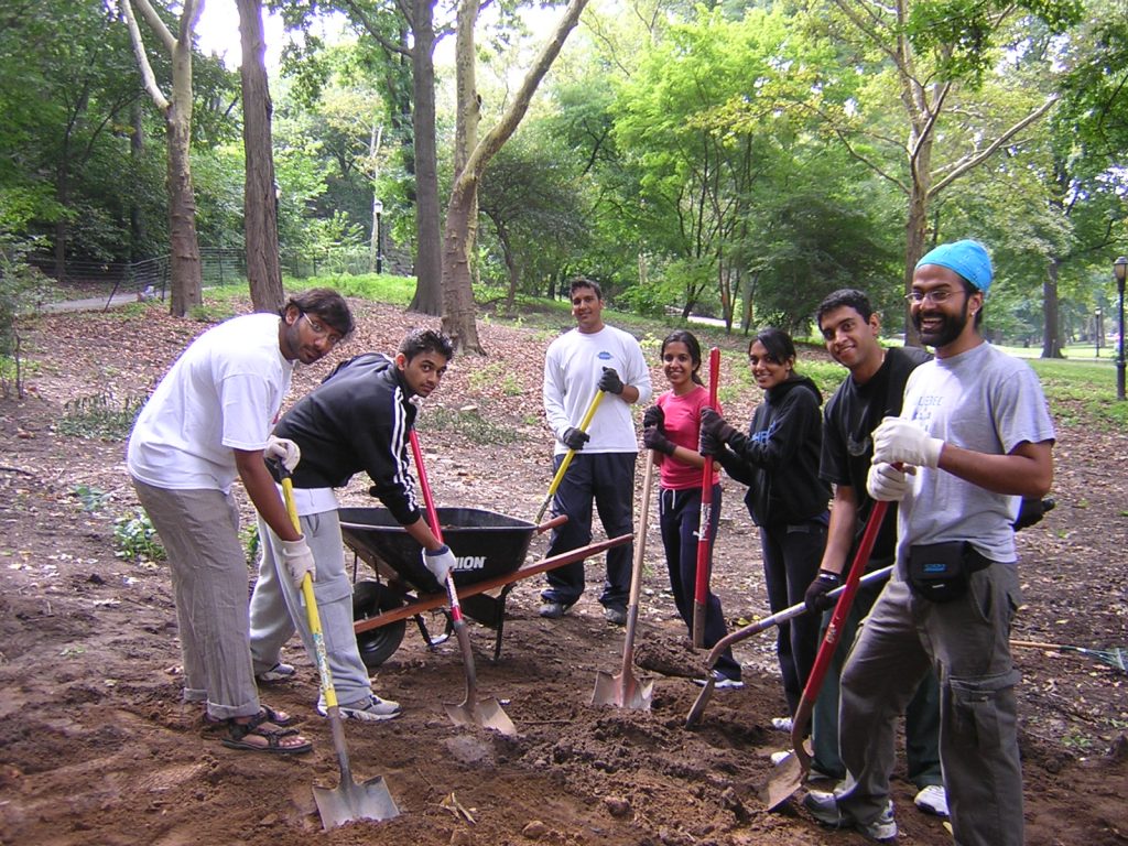 Young volunteers help to replenish soil in an area of the park