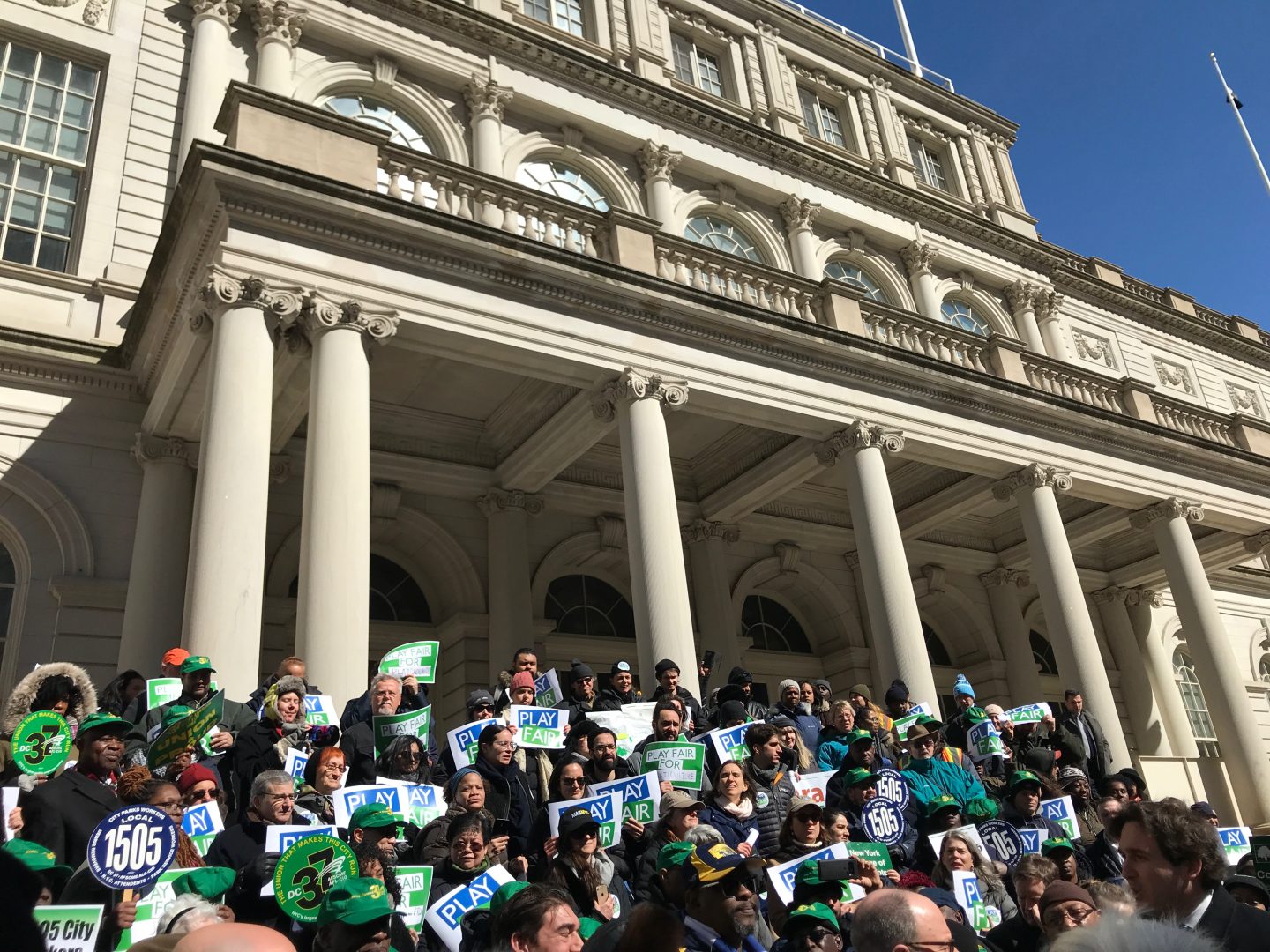 People rally in front of City Hall in support of more funding for all parks