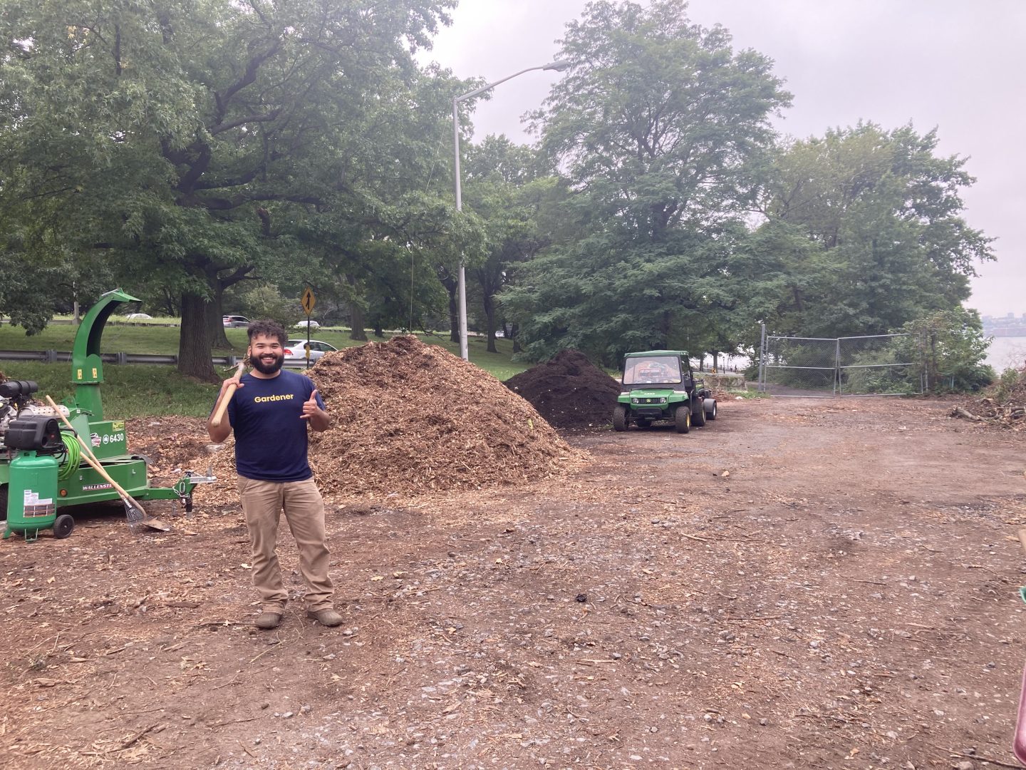 Staff member gives a thumbs up at the compost site