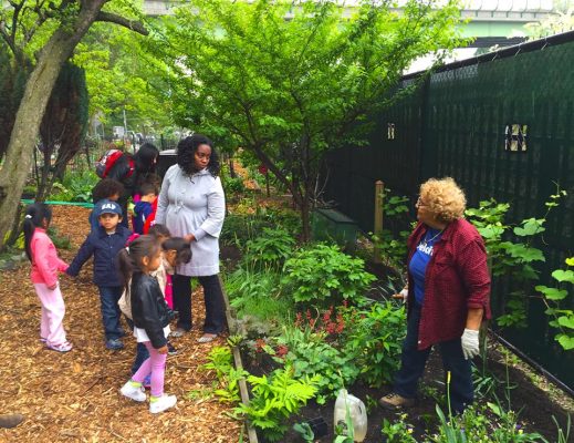 Jenny Benitez hosts a group of young volunteers in the community garden