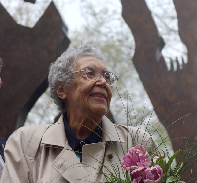 Sculptor Elizabeth Catlett stands in front of the Ralph Ellison Memorial